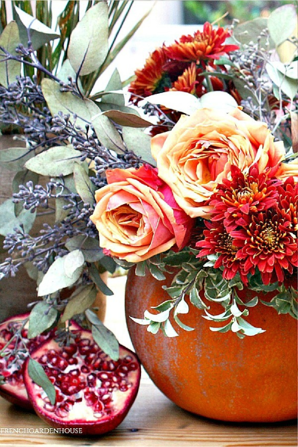 Breathtaking and vividly colorful fall blooms in a pumpkin vase for autumn splendor by FrenchGardenHouse. #pumpkin #centerpiece #fallfloral #autumntable