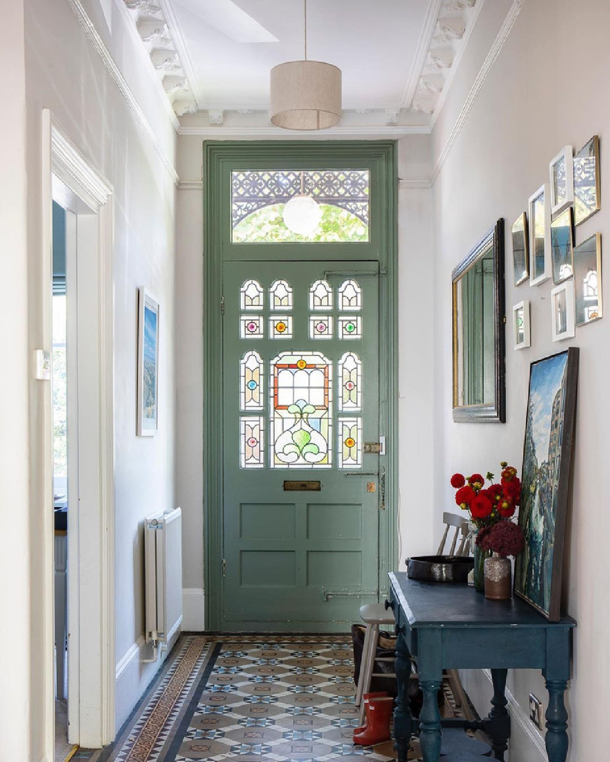 Beautiful entry in an English home with stunning sage green painted door - Imperfect Interiors. #entry #interiordesign #classicdesign #victorianhome #englishhome #sagegreen #greenpaint