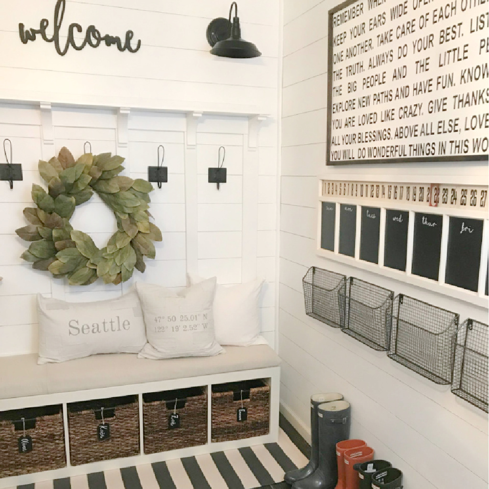 Ikea Kallax cubbies and bench in a farmhouse style mudroom area by Dreaming of Homemaking. #kallaxhack #mudroom #farmhousestyle