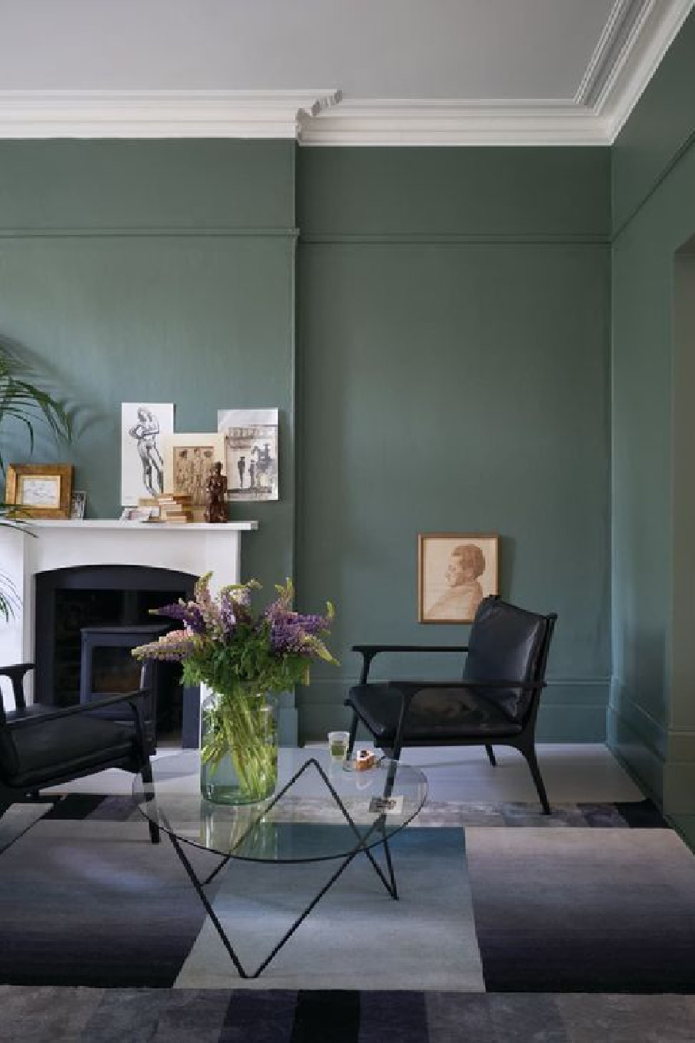 Farrow & Ball Green Smoke painted walls in a living room with European sophisticated style. #farrowandball #greensmoke #paintcolors #deepgreen #moodygreen #greenpaint