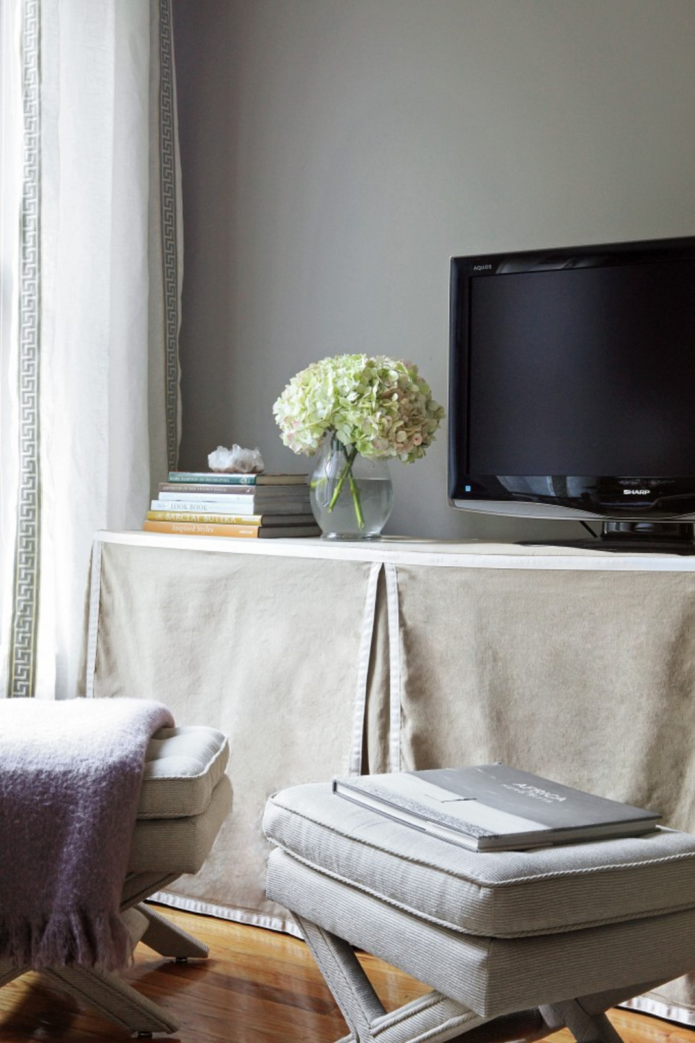 Slipcovered Kallax from Ikea used as a media console for a TV in a neutral space by Nicole Gibbons Style. #kallaxhack #ikeahacks