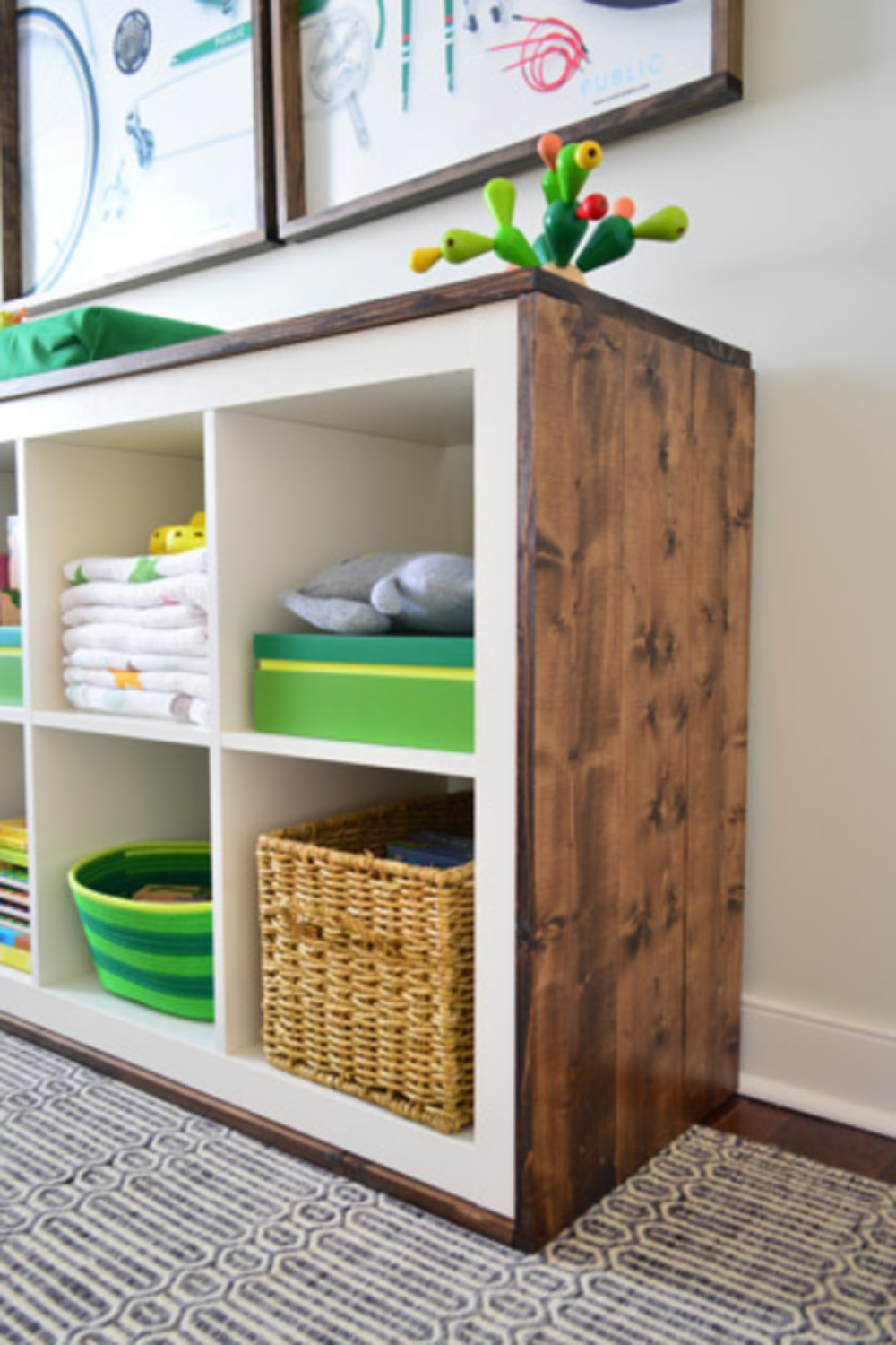 Kallax hack with changing table trimmed in wood - Young House Love. #kallaxhack #ikeahacks #nurserydesign #budgetdesign