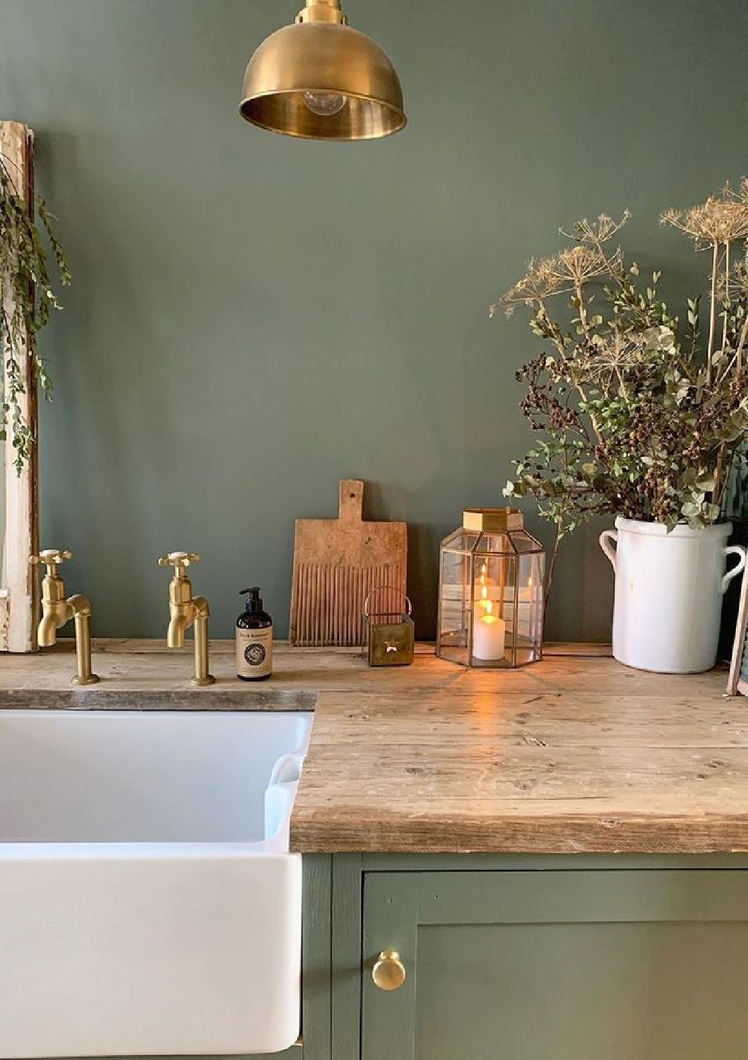 Farrow & Ball Green Smoke on walls and cabinets of a laundry room by Simply Scandi Katie. #farrowandball #greensmoke #paintcolors #darkgreen #greenpaint