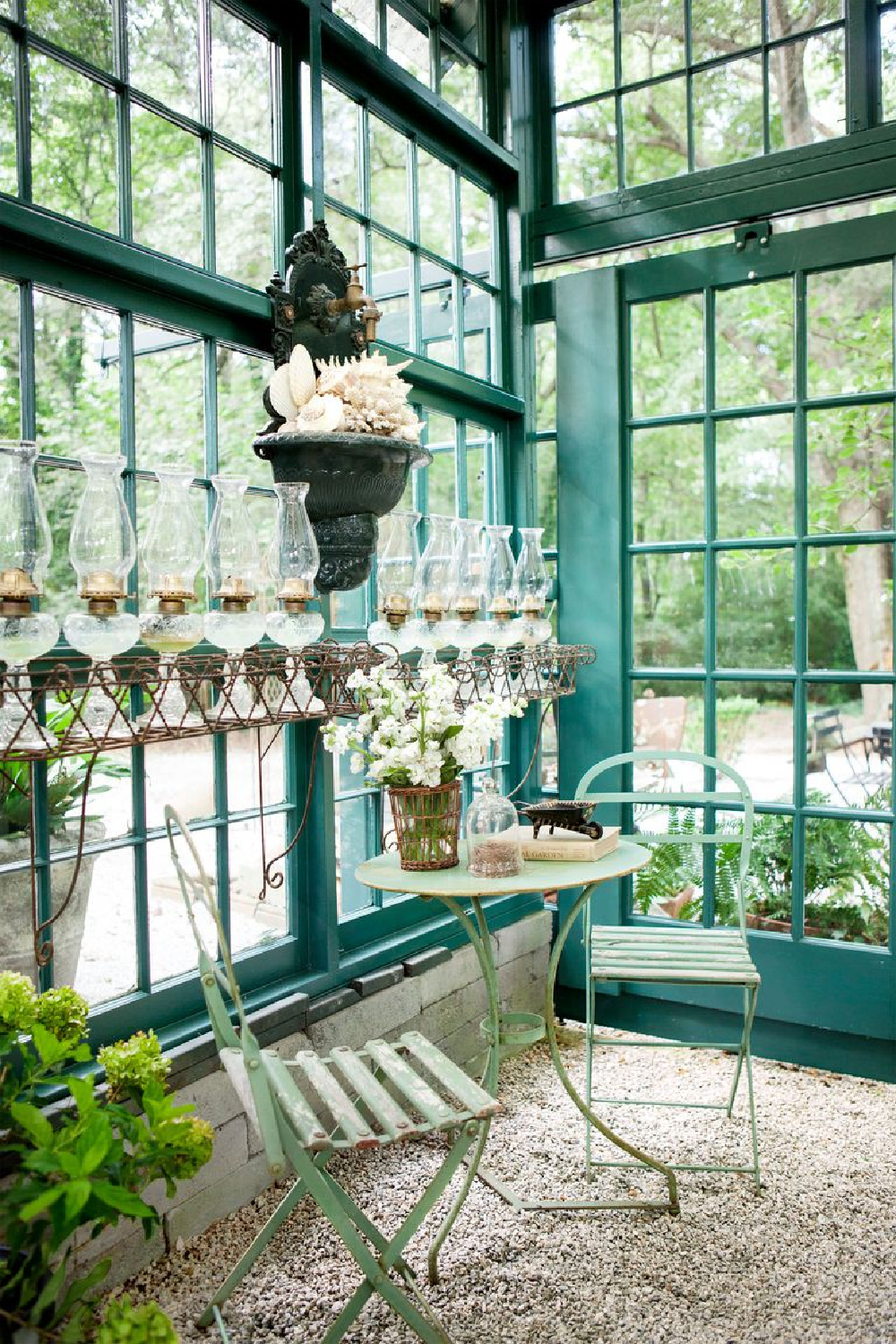 Chic she shed garden retreat with luxurious interior in backyard by Susanne Hudson. Green trim is painted Benjamin Moore Tarrytown Green.