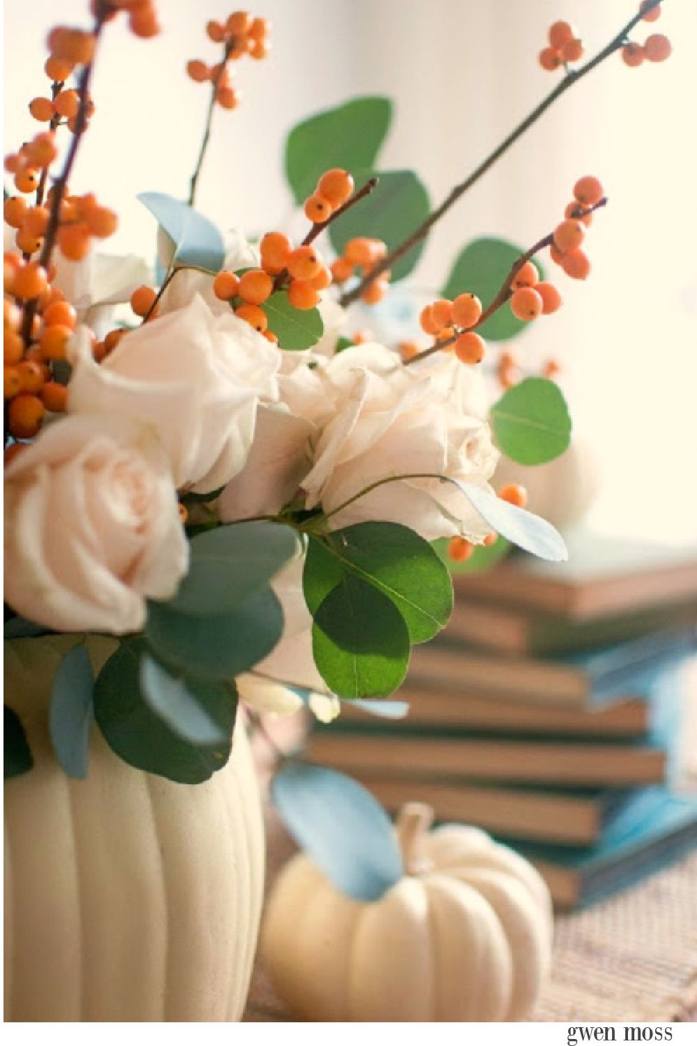 Gorgeous and simple fall centerpiece with white pumpkins, roses, bittersweet and eucalyptus - Gwen Moss. #falltable #pumpkincenterpiece #thanksgiving #tabledecor