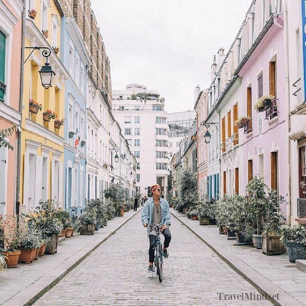 Paris pastels in fall offer a breathtaking design moment with these pretty facades on a street in Paris! @Travelmindset #parisinfall #parispastels #romantichomes #houseexteriors #pastels #autumn