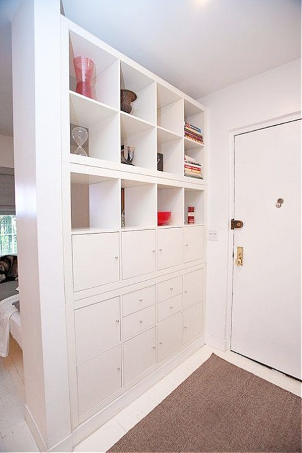 Kallax wall of storage to define an entry in an apartment. #kallaxhack #ikeakallax