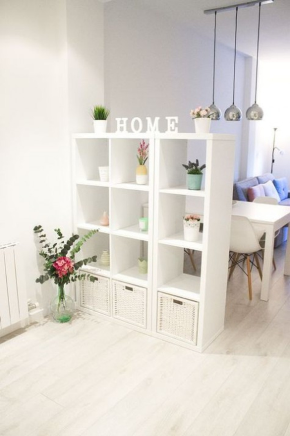 Airy room divider with Ikea's Kallax in a lofty space with white and sweet decor. #kallaxhack #roomdividers