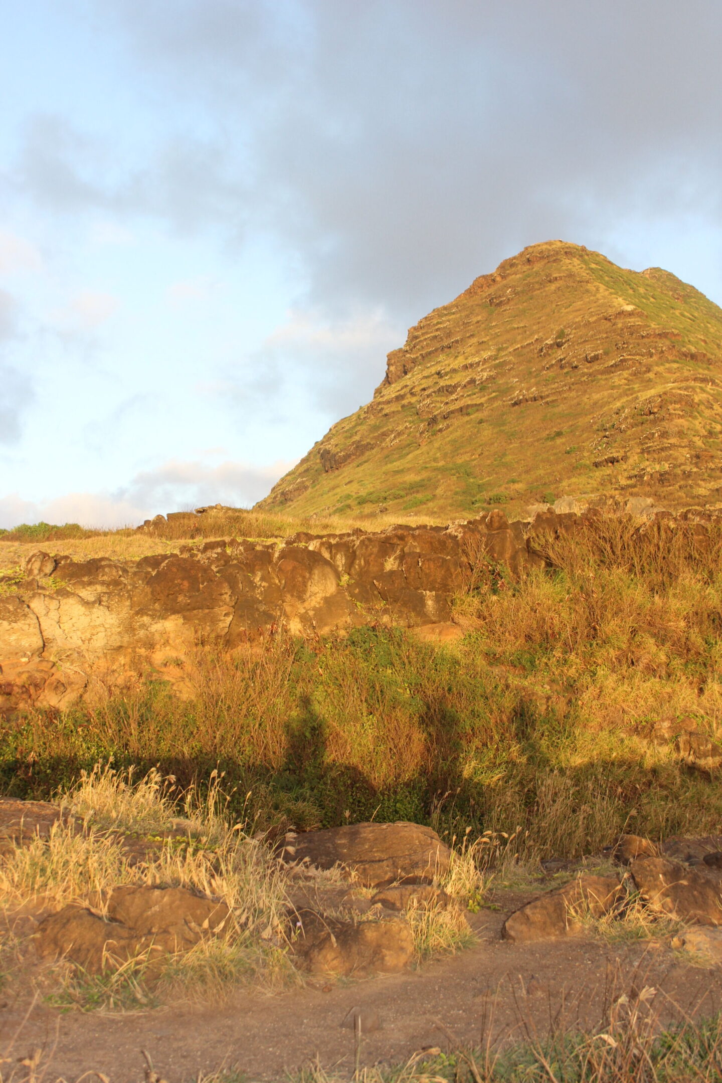 The glorious Pacific and mountainous landscape at Ka'ena Point on Oahu, where we hike to a seabird sanctuary to glimpse Laysan albatross beauty - Hello Lovely Studio. 