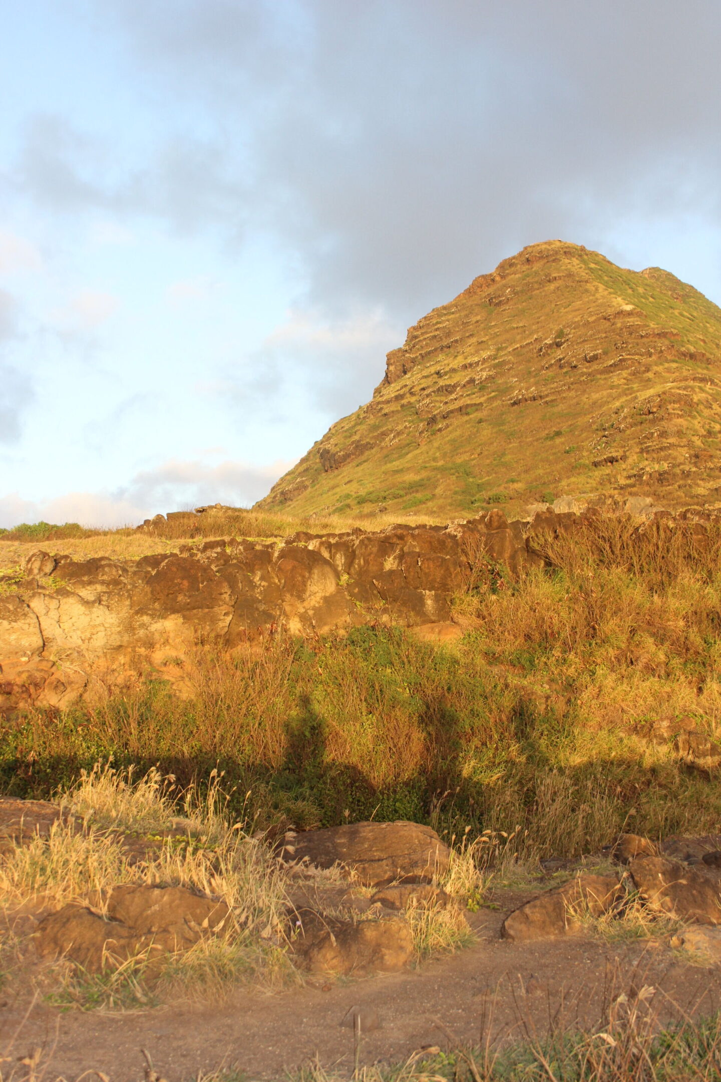 The glorious Pacific and mountainous landscape at Ka'ena Point on Oahu, where we hike to a seabird sanctuary to glimpse Laysan albatross beauty - Hello Lovely Studio.