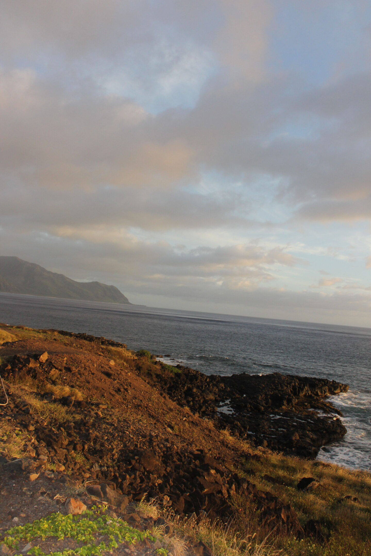 The glorious Pacific and mountainous landscape at Ka'ena Point on Oahu, where we hike to a seabird sanctuary to glimpse Laysan albatross beauty - Hello Lovely Studio.