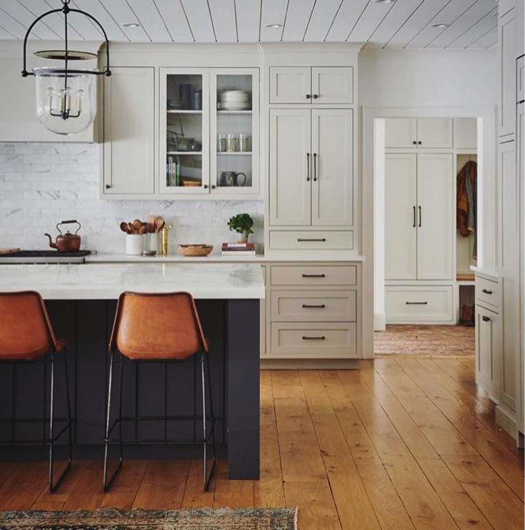 Cstom kitchen by Amber Interiors with warm beige or greige kitchen cabinets. #kitchendesign #puttycabinets #puttypaintcolor #mushroompaintcolor