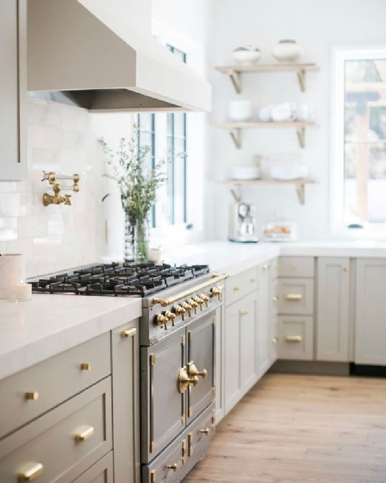 Serene kitchen with greige paint color on cabinets - @cherhousedesign. #kitchendesign  #greigekitchens #mushroomcabinets