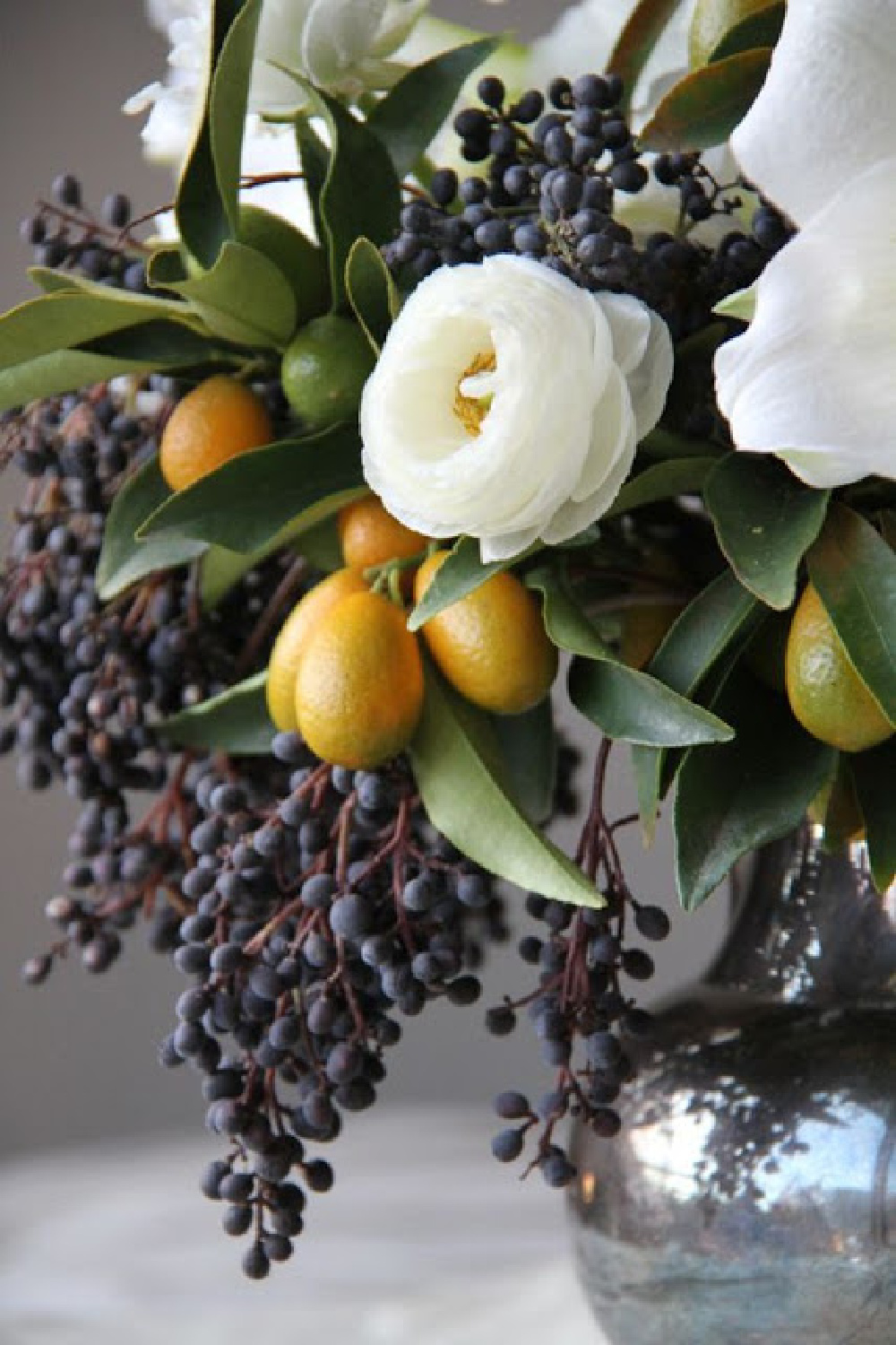 Gorgeous grapes in fall floral arrangement by Sarah Winward. #fallflowers #autumnfloral #floralarrangements 