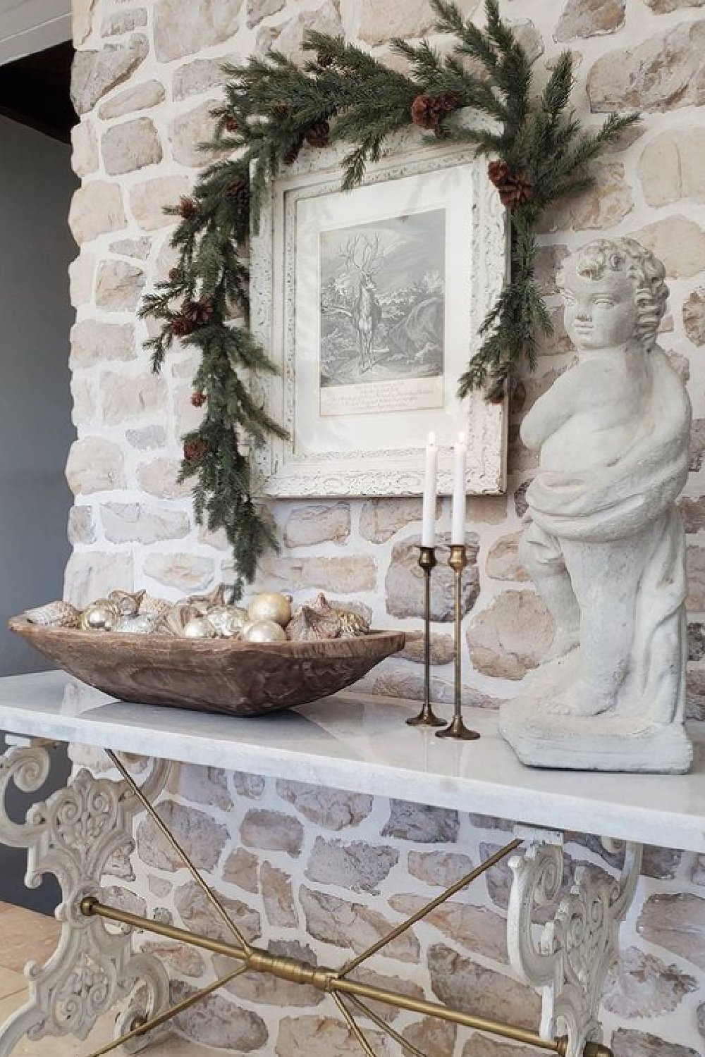 White French country Christmas decor with rustic stone, dough bowl with ornaments and cherub - The French Nest Co Interior Design.