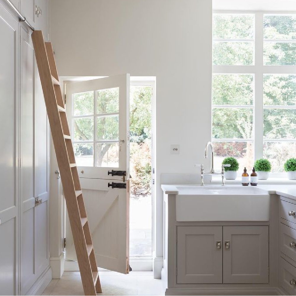 Beautiful mud room design with Dutch door, wall of cabinets, grey cabinets and farm sink. #mudroom #interiordesign