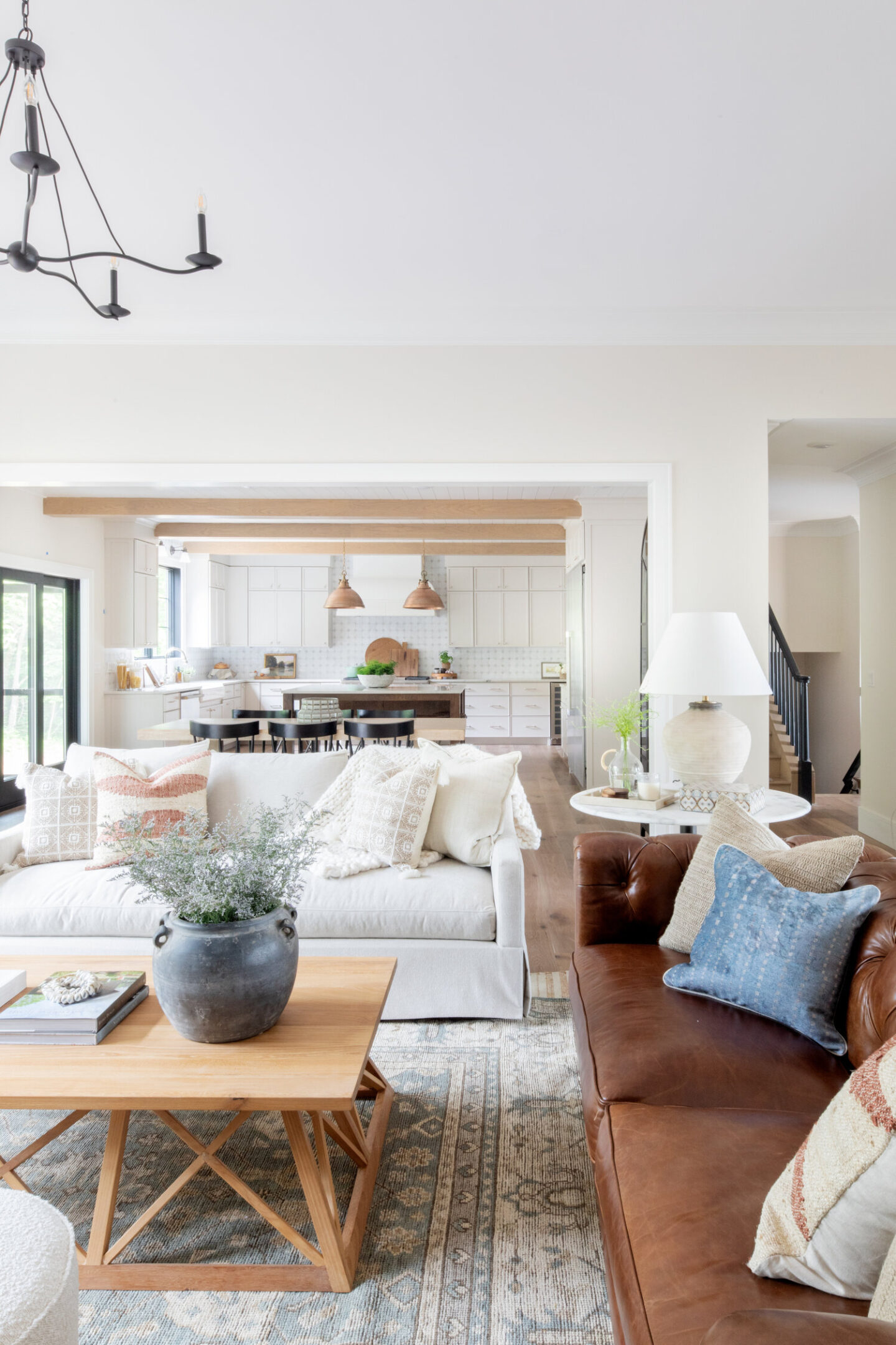 Great room with upholstered ivory sofa and tufted leather sofa - design by Bodine White; sofas by Scout & Nimble. #greatrooms