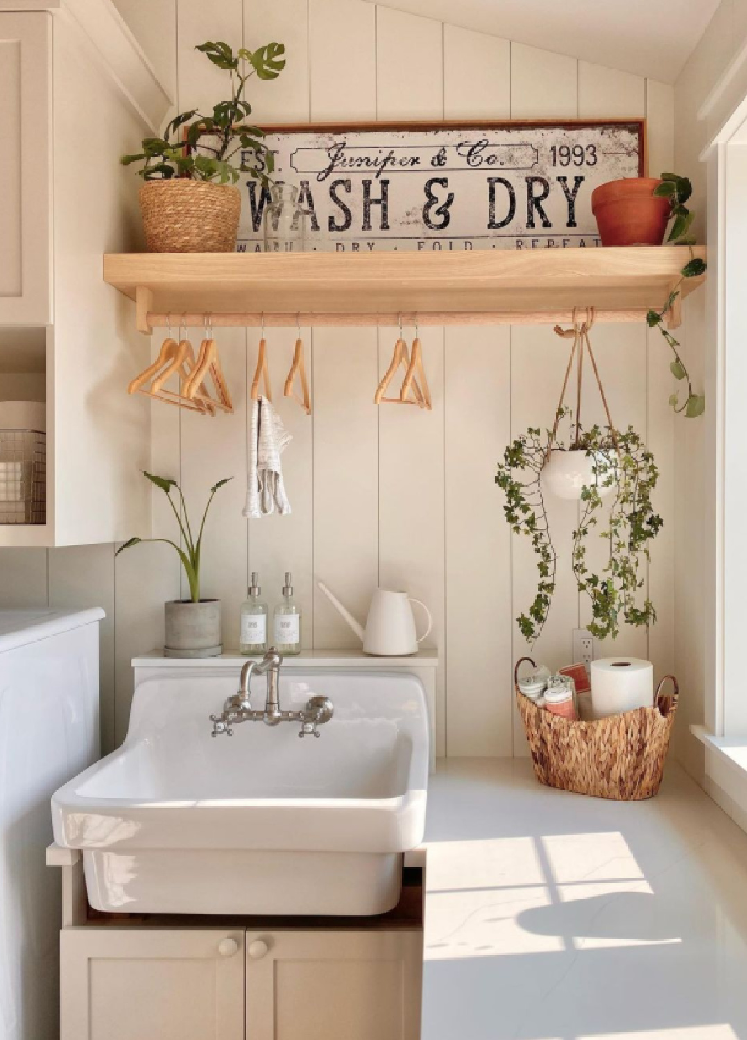 Beautiful farmhouse style country laundry room with space to hang clothing above farm sink and folding counter under window - @juniper.creek.farmhouse #farmhousestyle laundryrooms