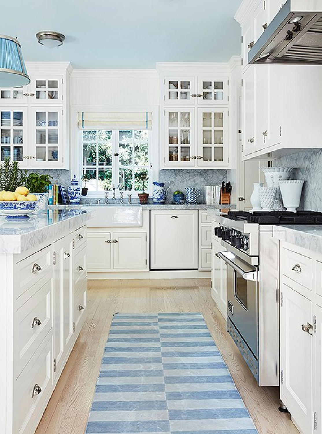 Beautiful blue traditional kitchen with white cabinets - design by Mark Sikes. #bluekitchen #blueandwhite #kitchendesign