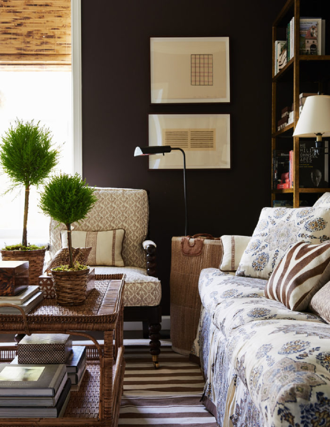 Dramatic black wall in a living space with traditional design by Mark Sikes.