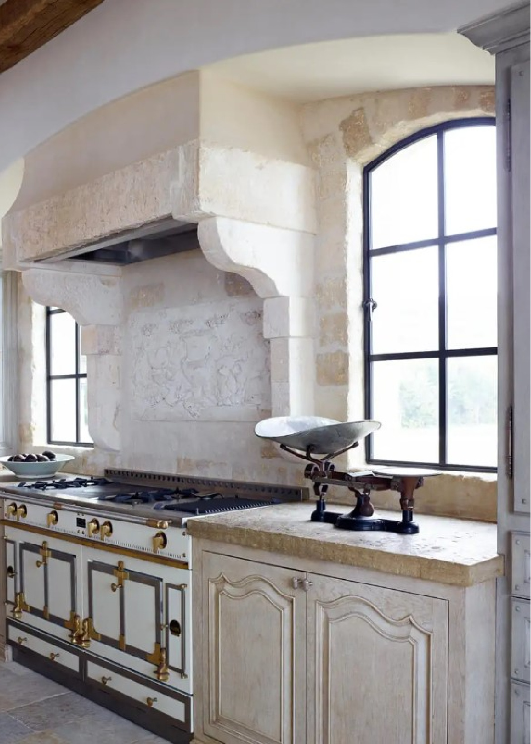 Rustic elegant French country kitchen with stone and pale color palette - The Strand, Dana Point - Ohara Davies Gaetano Interiors - Richard Powers Photo. #frenchkitchen #stonerangehood