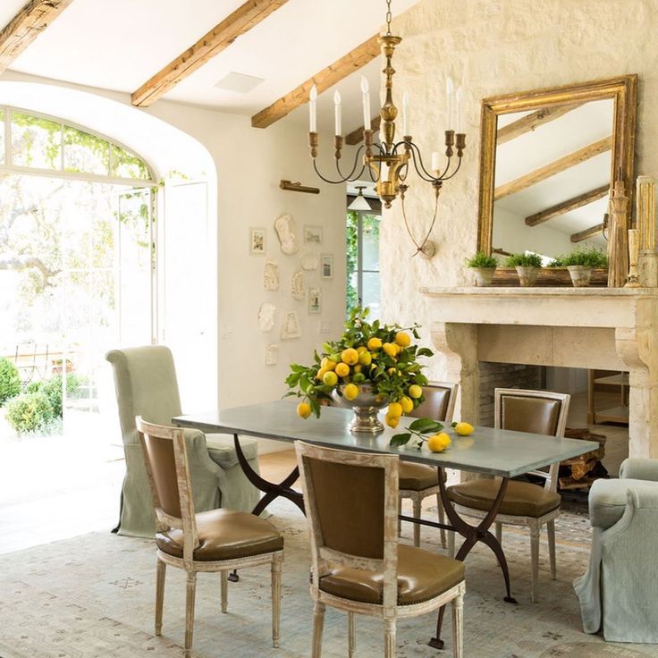 Patina Farm dining room with 19th century antique French stone fireplace - Giannetti Home. #patinafarm #interiordesign #frenchfarmhouse #diningroom #fireplace #limestone #frenchfireplace