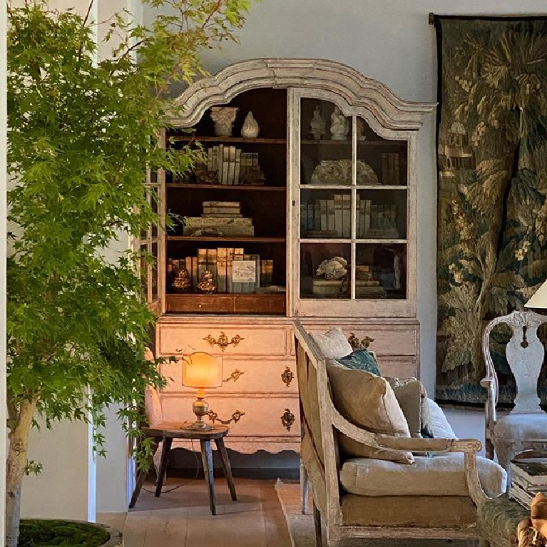 Patina Farm living room with Swedish Rococo antique cabinet, tapestry, European country furniture, and Old World charm - Giannetti Home.