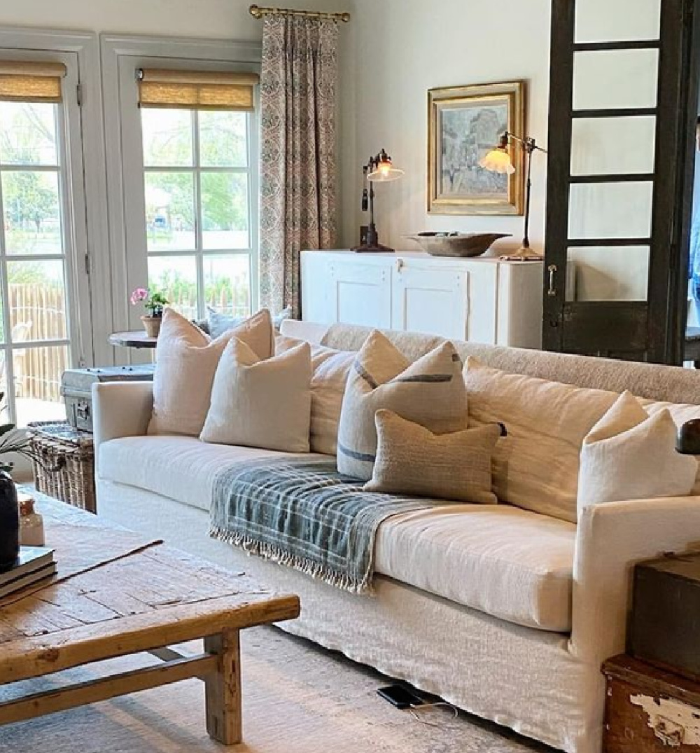 Rustic European country family room with Belgian linen sofa, black doors, and blue grey trim - @beljarhome. #europeancountry #belgianlinen