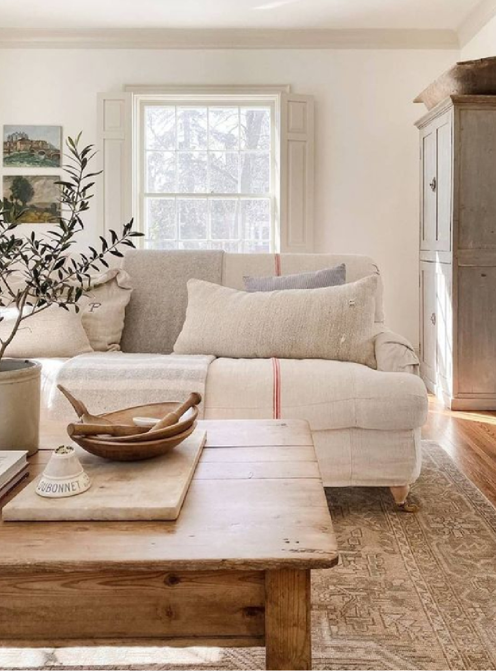 Understated and serene neutral interior with nubby linen sofa and putty shutters - @burtsbrisplease. #europeancountry #neutraldecor #belgianstyle