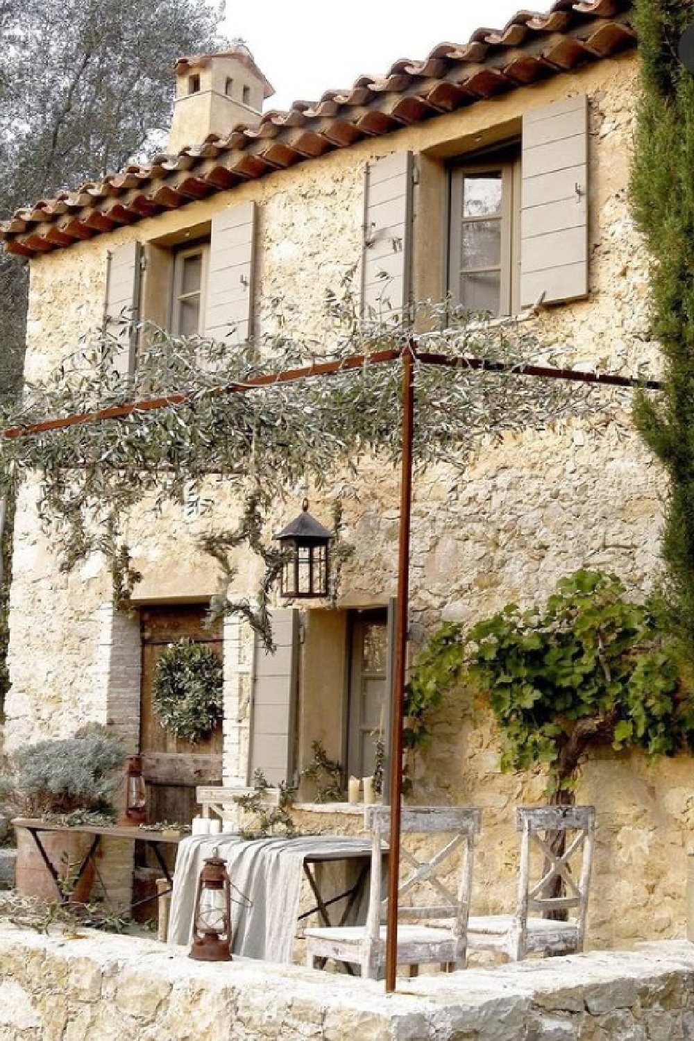 Provence farmhouse with stone exterior, pergola and putty shutters - photo by Henri del Olmo. #frenchfarmhouse #provencefarmhouse #frenchcountry