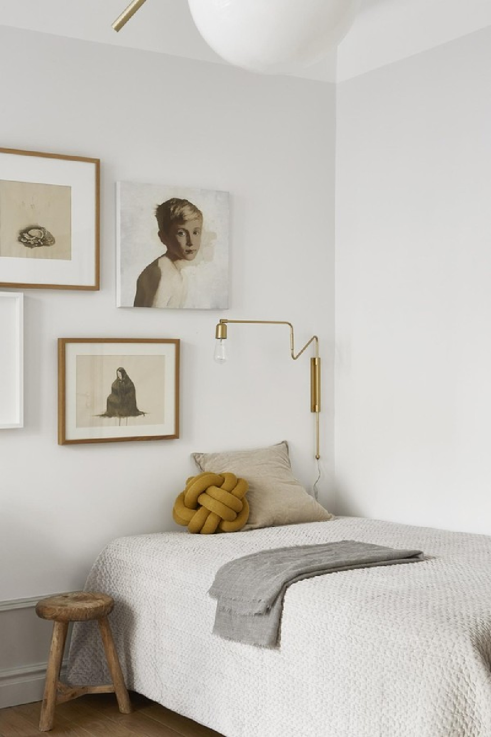 Gallery wall in a serene white Stockholm bedroom - Fantastic Frank. #serenebedroom #gallerywall #swedishdesign