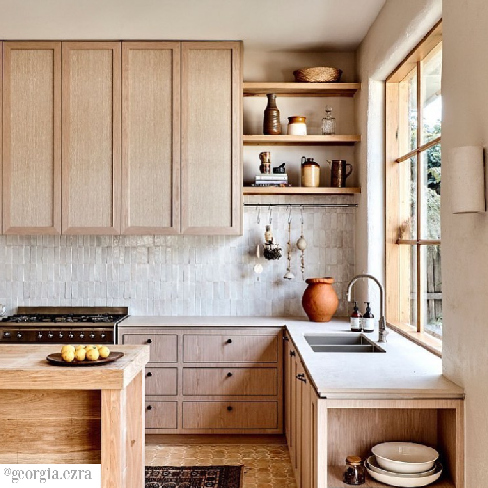 Zellige tile backsplash in a magnificent kitchen with light wood cabinets, open shelves, and a neutral palette - @georgia.ezra. #neutralkitchen #zelligetile