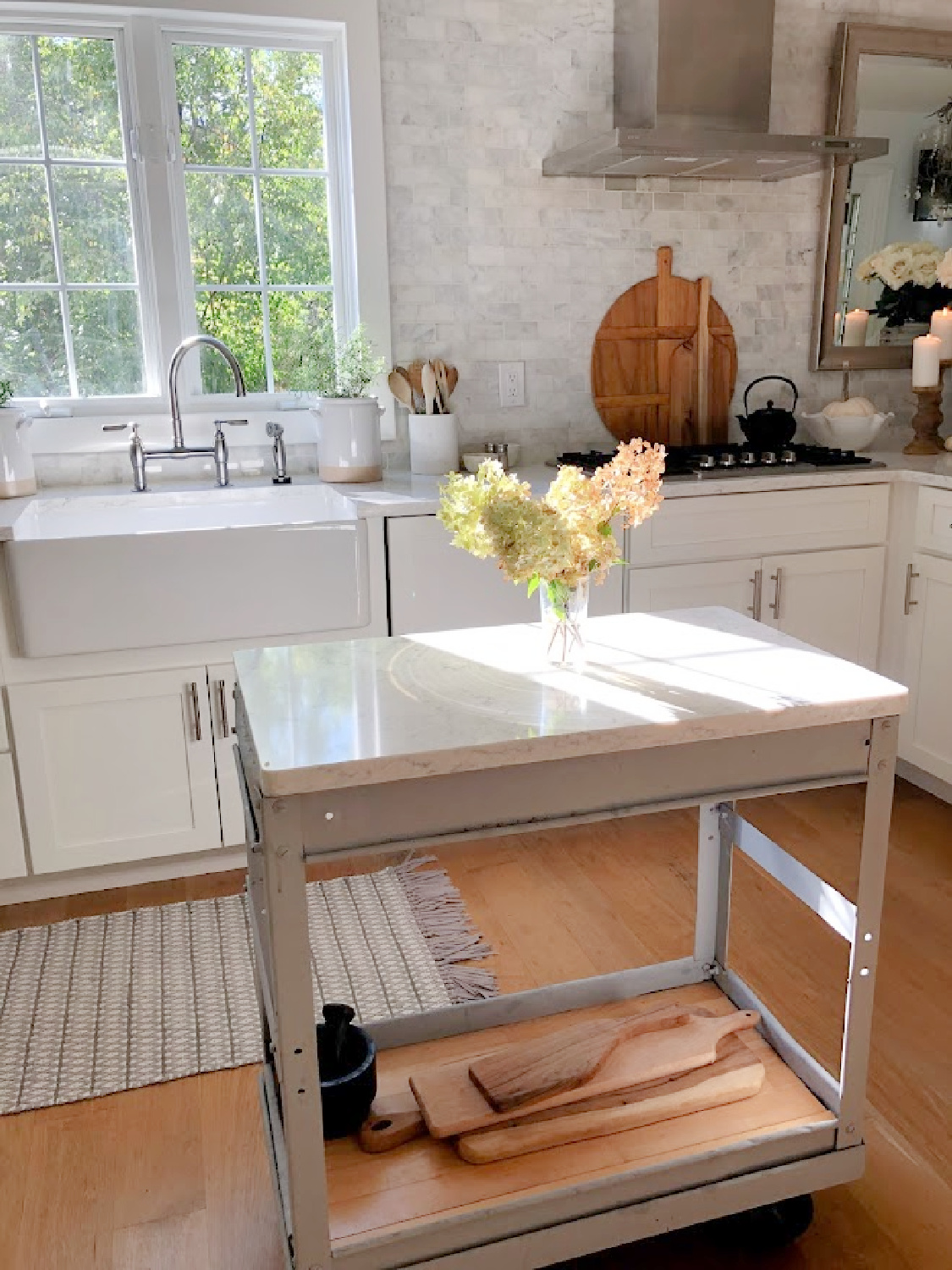 Serene white kitchen in early fall with hydrangea - Hello Lovely Studio.