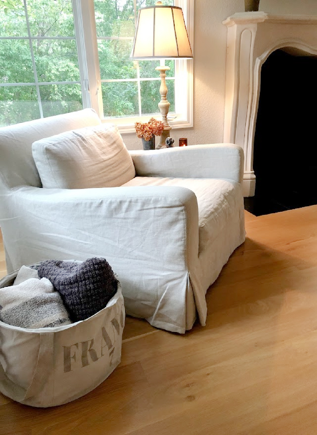 My Belgian linen arm chair in living room with white oak hardwoods - Hello Lovely Studio.