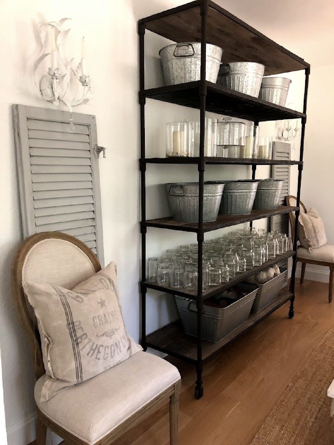 Rustic shelves with galvanized tubs to organize in the dining room - Hello Lovely Studio.