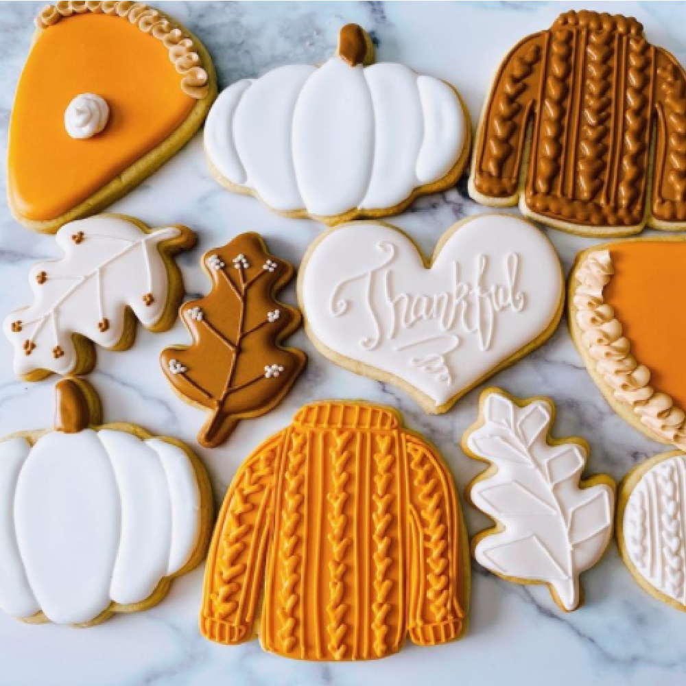 Charmingly sweet Thanksgiving fall autumn frosted cookies in pumpkin, sweater, and leaf shapes - @cookiebosshtx. #fallcookies