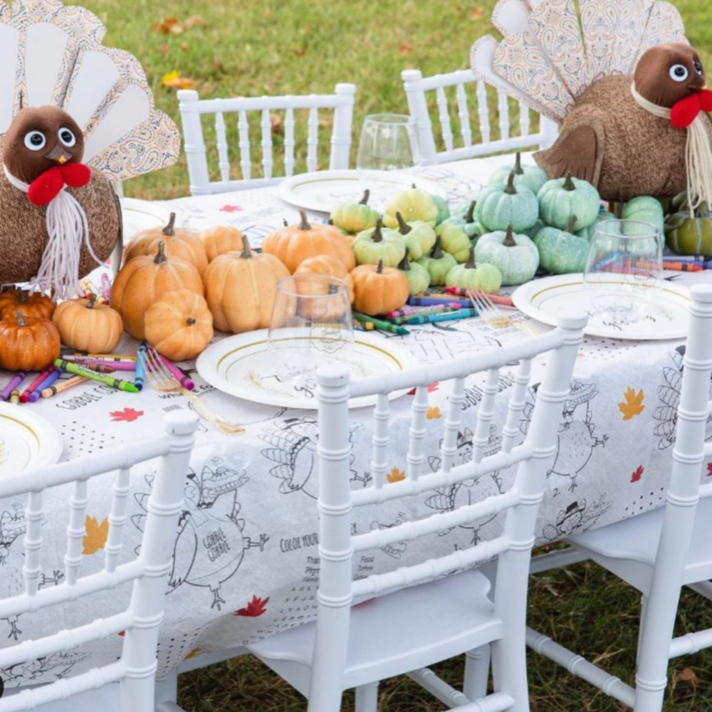 Whimsical Thanksgiving kids table tablescape with turkeys, pastel pumpkins, and outdoor setting - @mrssouthernsocial. #thanksgivingtable #tablescapes #kidstable