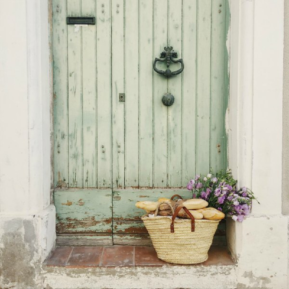Charming weathered green door! French farmhouse design inspiration, house tour, French homewares and market baskets from Vivi et Margot. Photos by Charlotte Reiss. Come be inspired on Hello Lovely and learn the paint colors used in these beautiful authentic French country interiors. #frenchfarmhouse #hellolovelystudio #frenchcountry #europeanfarmhouse