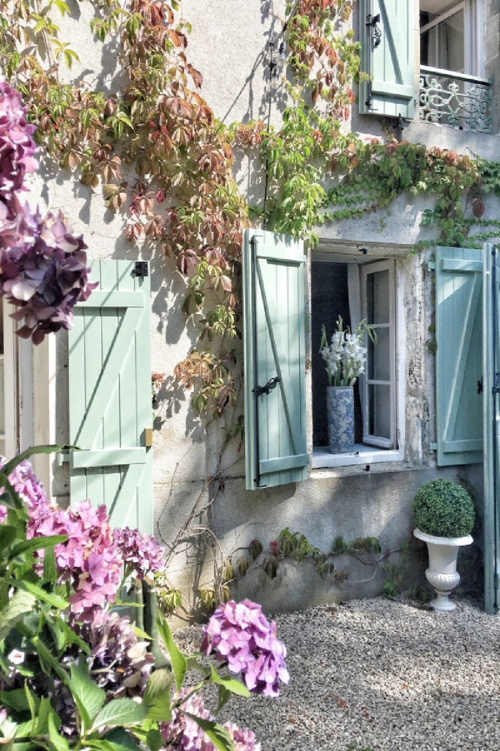 Green shutters on a French farmhouse exterior with climbing vines. #frenchhouses #vivietmargot #greenshutters
