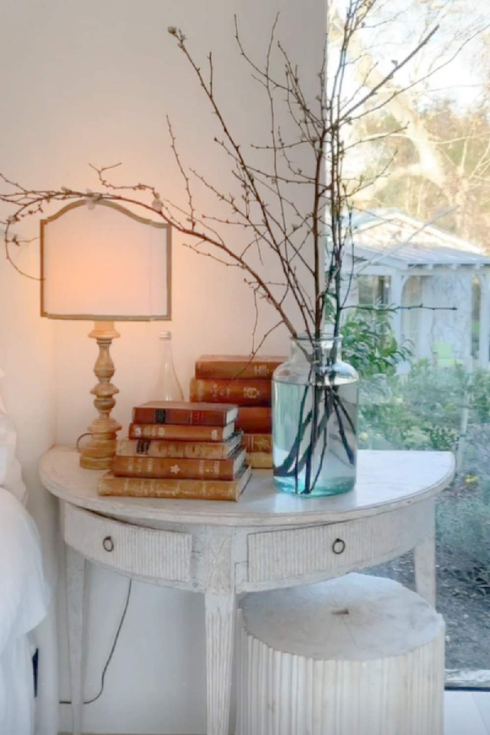 Swedish antique demilune bedside table with fluted drawers in a romantic bedroom at Patina Farm (a European country farmhouse by Giannetti Home). #brookegiannetti #frenchfarmhouse #frenchbedrooms