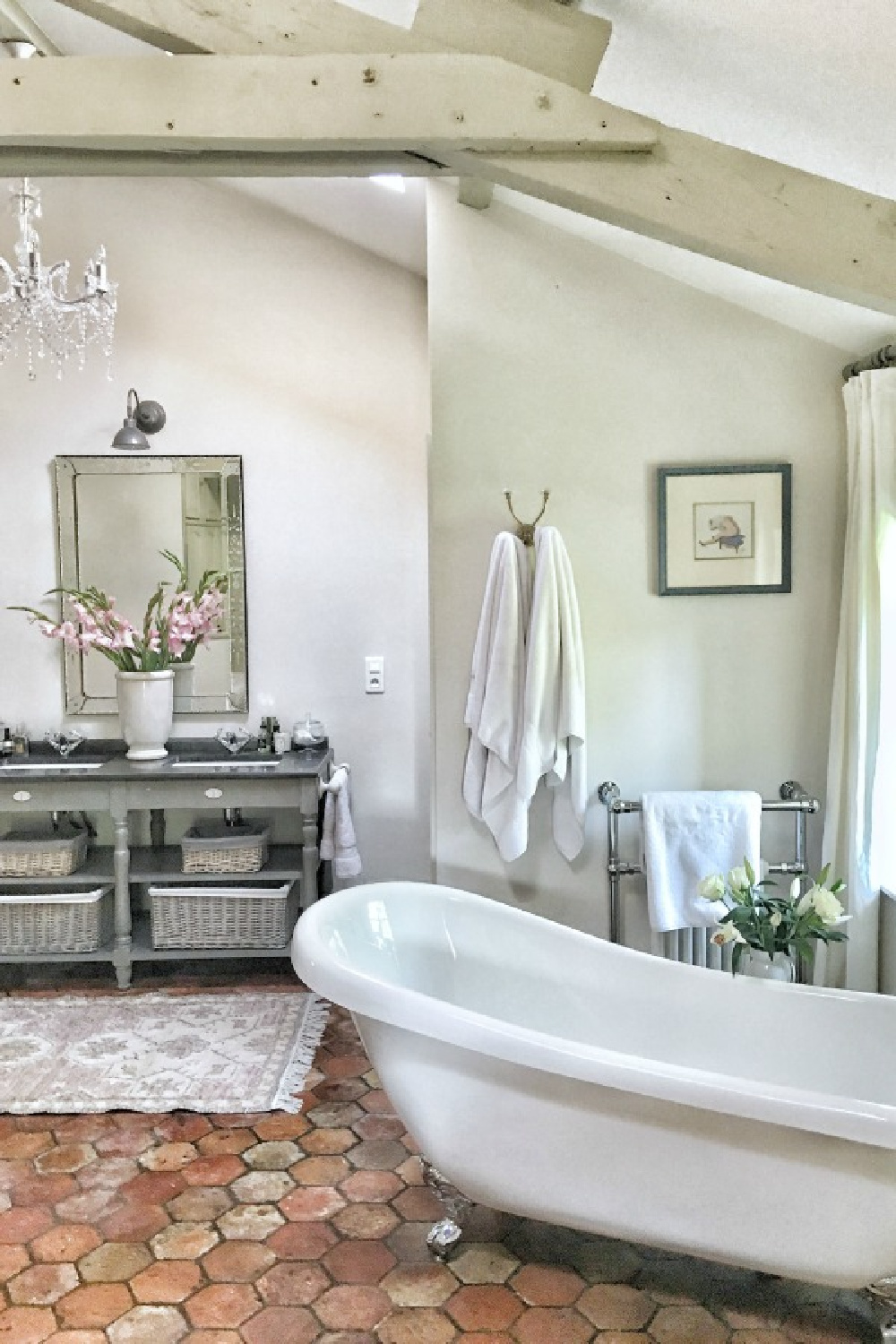 Farrow and Ball Strong White on walls in a French farmhouse bathroom with terracotta hex tile and clawfoot tub. Vivi et Margot. #frenchbathroom #frenchcountrystyle