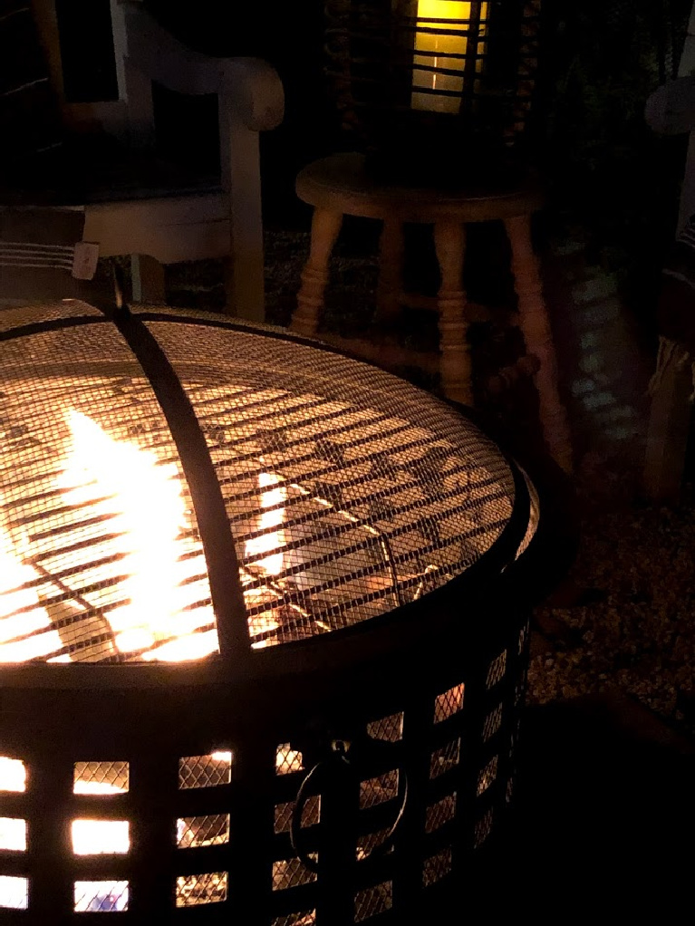 Wood burning fire pit in our French country courtyard with pea gravel is the perfect little addition to enjoy roasted marshmallows and family time. #firepit #woodburningfirepit #outdoordecor #patiodecor #hellolovelystudio