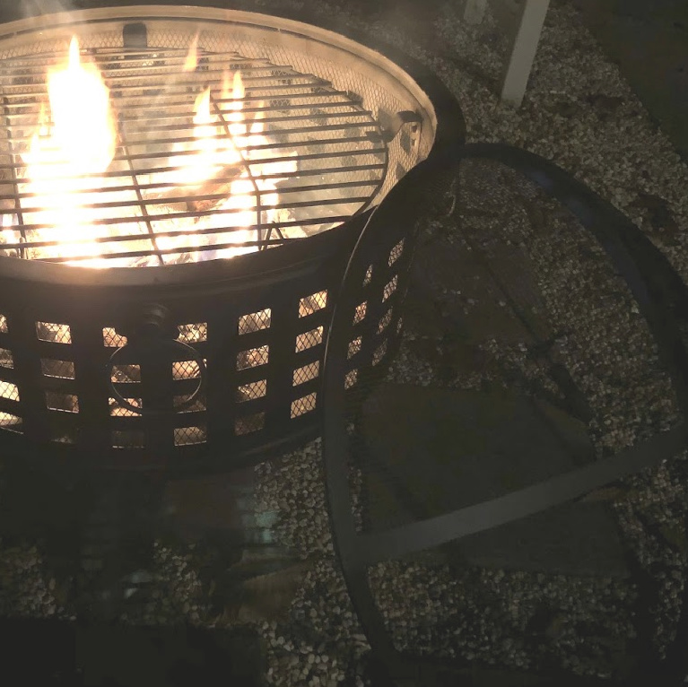 Wood burning fire pit in our French country courtyard with pea gravel is the perfect little addition to enjoy roasted marshmallows and family time. #firepit #woodburningfirepit #outdoordecor #patiodecor #hellolovelystudio