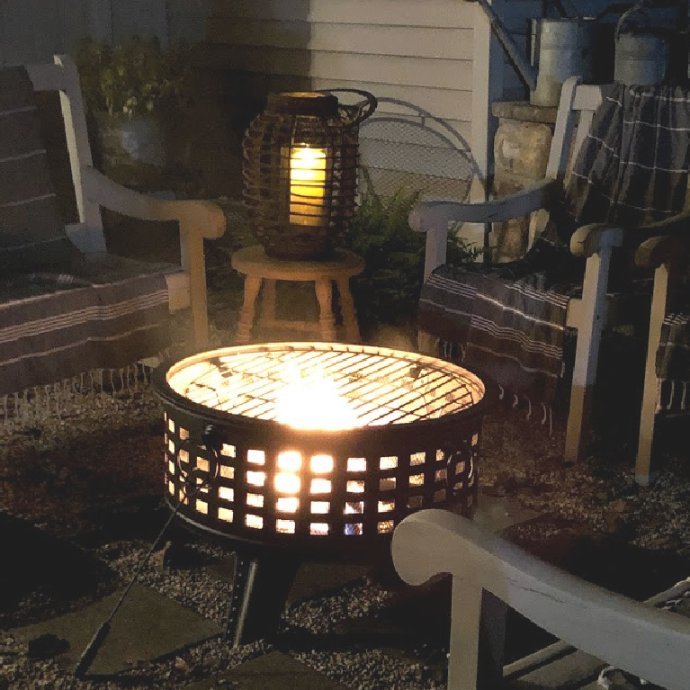 Wood burning fire pit in our French country courtyard with pea gravel is the perfect little addition to enjoy roasted marshmallows and family time. #firepit #woodburningfirepit #outdoordecor #patiodecor #hellolovelystudio