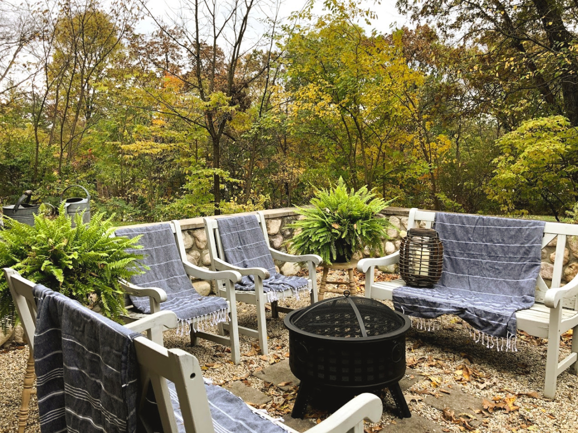 Wood burning fire pit in our French country courtyard with pea gravel is the perfect little addition to enjoy roasted marshmallows and family time. #firepit #woodburningfirepit #outdoordecor #patiodecor #hellolovelystudio