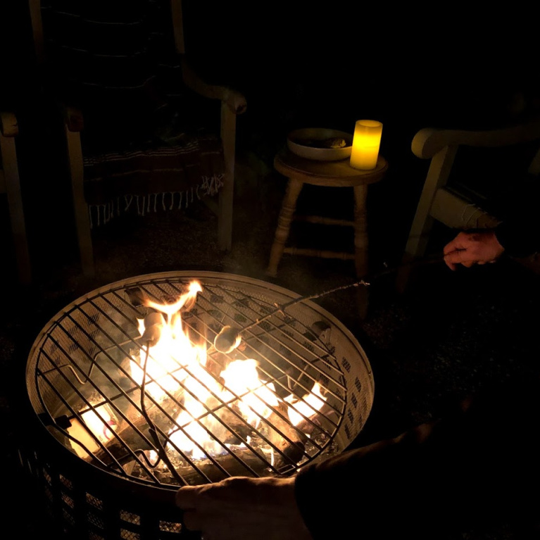 Wood burning fire pit in our French country courtyard with pea gravel is the perfect little addition to enjoy roasted marshmallows and family time. #firepit #woodburningfirepit #outdoordecor #patiodecor #hellolovelystudio