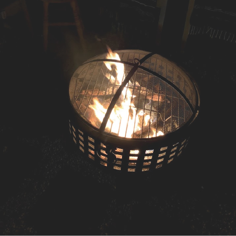 Wood burning fire pit in our French country courtyard with pea gravel is the perfect little addition to enjoy roasted marshmallows and family time. #firepit #woodburningfirepit #outdoordecor #patiodecor #hellolovelystudio