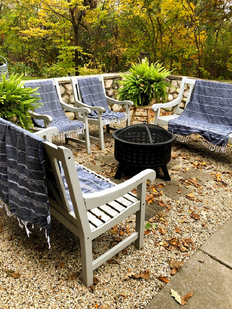 Wood burning fire pit in our French country courtyard with pea gravel is the perfect little addition to enjoy roasted marshmallows and family time. #firepit #woodburningfirepit #outdoordecor #patiodecor #hellolovelystudio