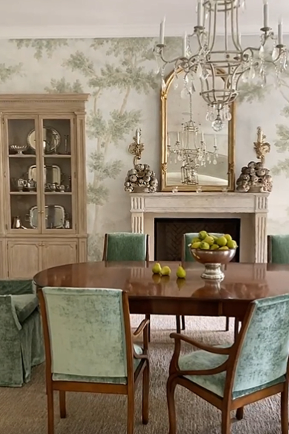 Elegant French country dining room with green accents, tree mural, and antique fireplace from Exquisite Surfaces - design by Giannetti Home. #interiordesign #diningrooms #traditionalstyle