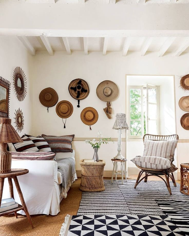 Rustic refined living room in France (Luncinda Chambers) with charming straw hats on wall - @houseandgardenuk. #frenchcountry #frenchrustic #rusticrefined #livingroom #interiordesign #livingrooms #rusticdecor